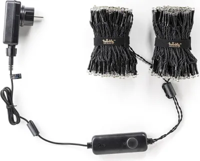 A black power adapter connected to a string of LED lights, laid out on a white background.