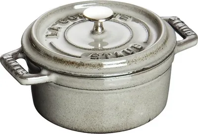 A close-up studio shot of a Staub cast iron pot.