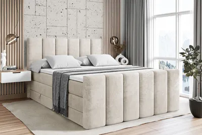 A bedroom scene with a large bed as the focal point, decorated with pillows and a throw blanket. The room has modern decor with wooden accents and a large window with curtains.