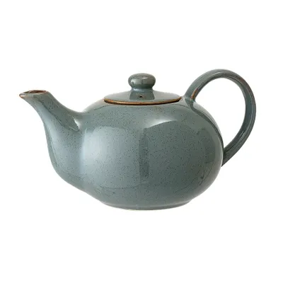 A side view of a green ceramic teapot with a lid and handle, isolated on a white background.
