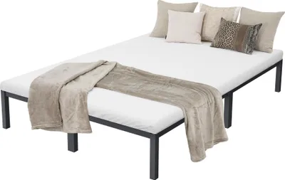 A white mattress with a brown blanket and pillows on a dark gray metal bed frame, shown from a slight angle.
