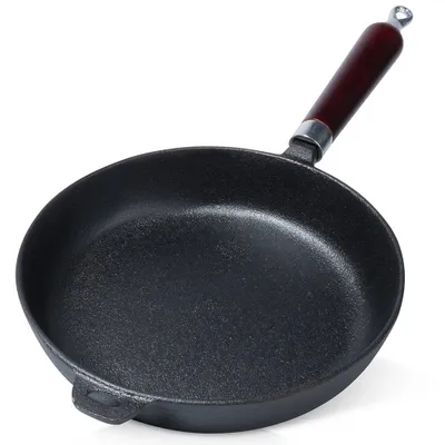 A cast iron frying pan with a wooden handle, shown from a slightly elevated angle against a white background.