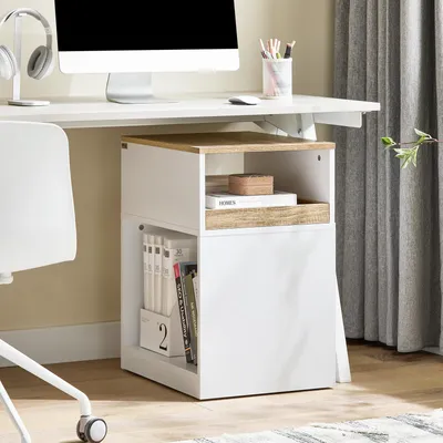 A white office chair next to a white and wood desk with a computer, headphones, and books.