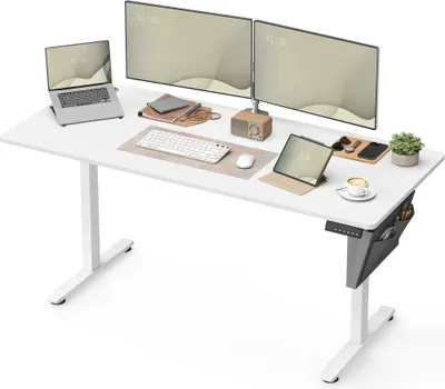 A white adjustable standing desk with multiple monitors, a laptop, tablet, keyboard, mouse, and other accessories.