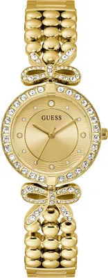 A close-up studio shot of a gold Guess watch with crystal embellishments.