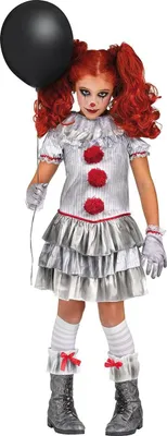 A young girl dressed in a clown costume holding a black balloon.