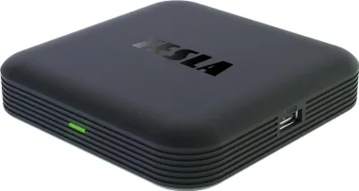A black media box with the TESLA logo on top.