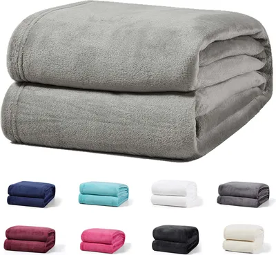 A stack of two gray blankets is shown at the top, with smaller swatches of different colored blankets arranged below.