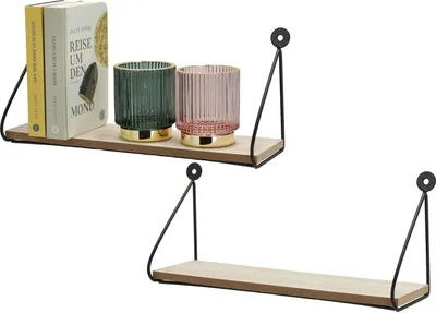 Two wall shelves are displayed against a white background. The top shelf holds two decorative glass vases and two books. The bottom shelf is empty.