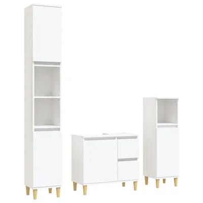 A set of three white bathroom cabinets with wooden legs against a white background.