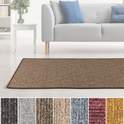 A rug in a living room setting with a sofa and side table.