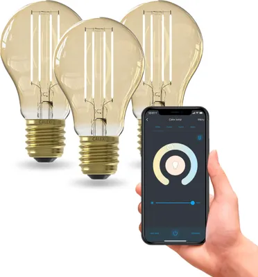 A hand holding a smartphone displaying a smart lighting app, with three smart LED bulbs in the background.