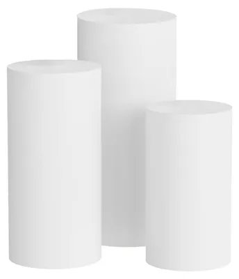 Three white cylindrical pedestals of varying heights are arranged together against a white background.