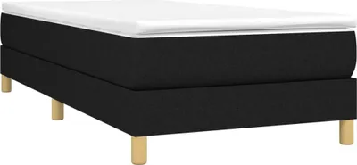 A black bed frame with a white mattress on top, supported by four wooden legs.