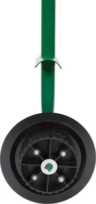 A close-up view of a green pole with a black wheel attached to its base.