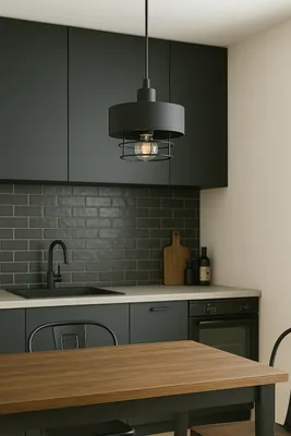 A modern kitchen with dark cabinets, subway tile backsplash, and a wooden dining table in the foreground.