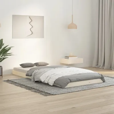 A minimalist bedroom scene with a wooden bed frame and bedding.