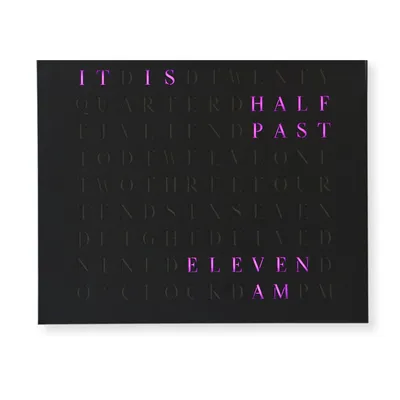 A black word clock with purple illuminated letters displaying the time.