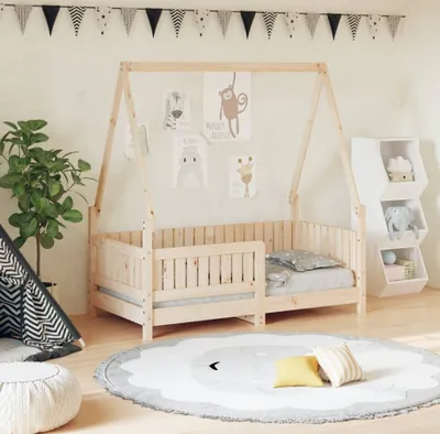 A child's bedroom with a wooden house bed, toys, and decorations.