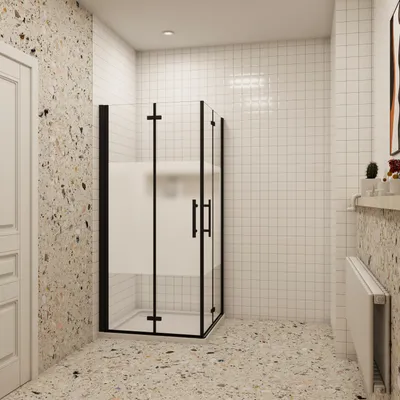 A modern bathroom with a glass shower enclosure, tiled walls, and terrazzo flooring.