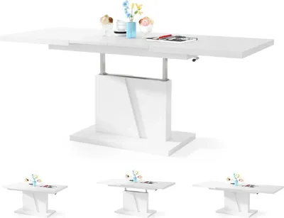 A white dining table with a pedestal base, shown in its extended state with decorative items on top.