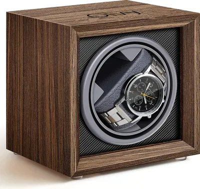 A wooden watch winder with a watch inside, shown from a slightly angled front view.