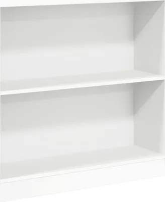 A close-up view of an empty white bookshelf.