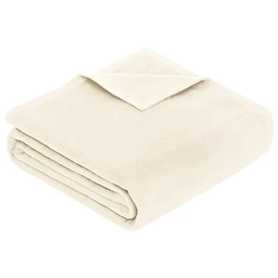 A folded cream-colored blanket on a white background.