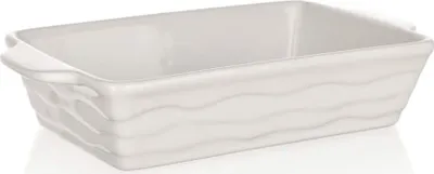 A white ceramic baking dish with a wavy texture on the sides.