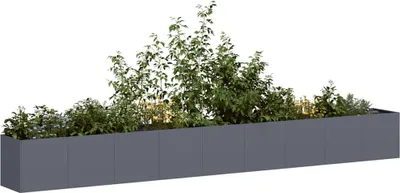 A long, rectangular planter filled with various green plants against a white background.