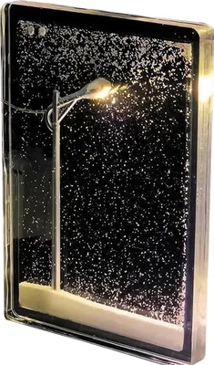 A decorative snow globe with a street lamp and snow effect.