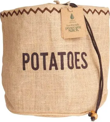 A burlap sack for storing potatoes, with text and a tag attached.