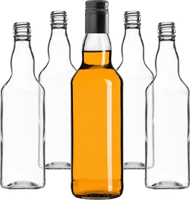 A group of empty glass bottles and one bottle filled with amber liquid, arranged in a row.