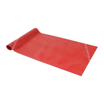 A red exercise band is laid out on a white background, with one end rolled up.