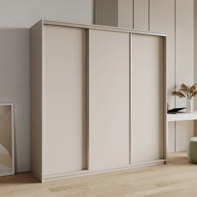 A modern, minimalist bedroom scene featuring a large sliding door wardrobe.