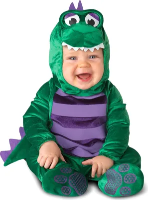 A baby wearing a dinosaur costume.