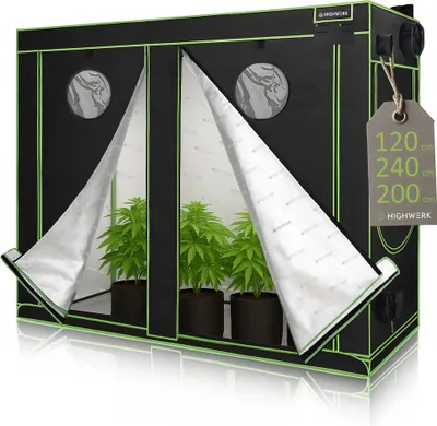 A grow tent with plants inside, displayed on a reflective surface.