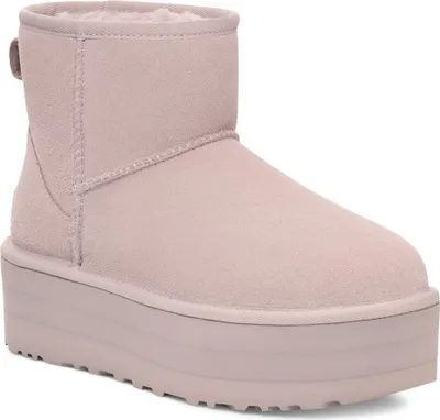 A single pink UGG boot with a platform sole is shown against a white background.