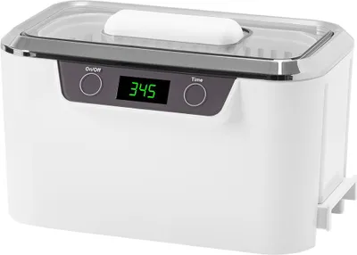 A white ultrasonic cleaner with a digital display and control buttons.