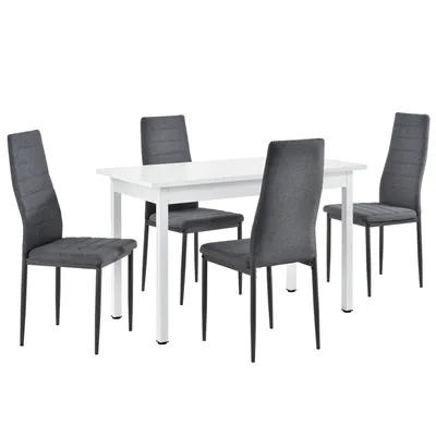 A white dining table with four gray chairs.
