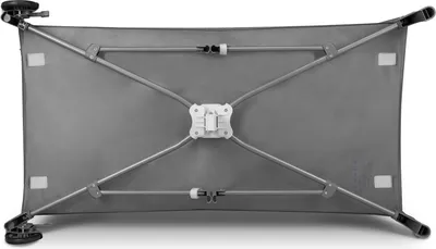 The underside of a baby travel cot with its frame and support structure.