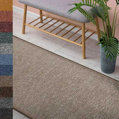 A beige runner rug in a hallway with a bench and a plant.
