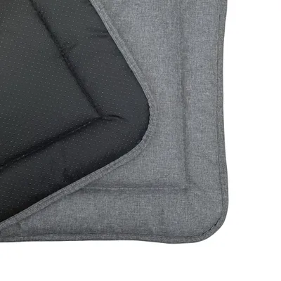 A close-up view of a dog mat, showing the texture of the fabric and the dotted pattern on the underside.