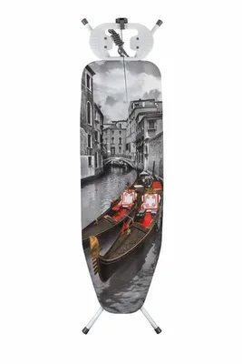 An ironing board with a Venice canal scene printed on it, standing on its legs.
