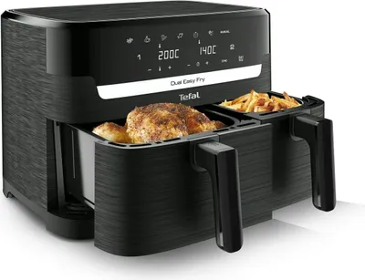 A black dual air fryer with a whole chicken in one basket and french fries in the other. The digital display shows cooking temperatures.