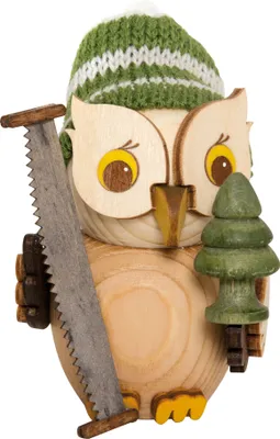 A wooden owl figurine dressed as a forest worker, holding a saw and a small Christmas tree.