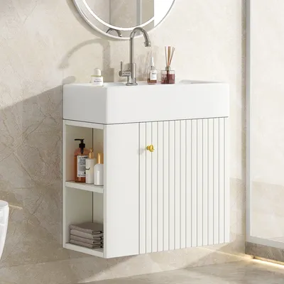 A white bathroom vanity with a sink and faucet, mounted on a tiled wall.