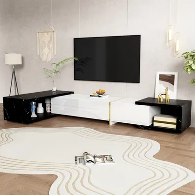 A modern living room with a TV stand, TV, and rug.