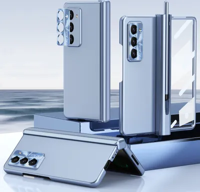 Three blue foldable phone cases are displayed on a reflective surface with a blurred ocean background.
