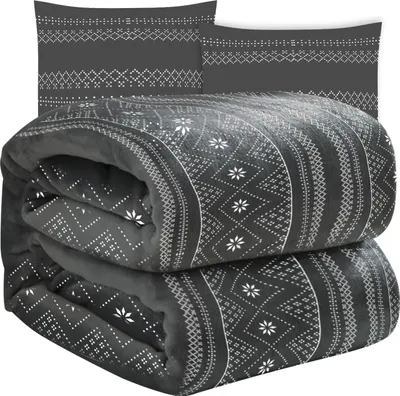 A folded blanket and two pillowcases with a geometric pattern.
